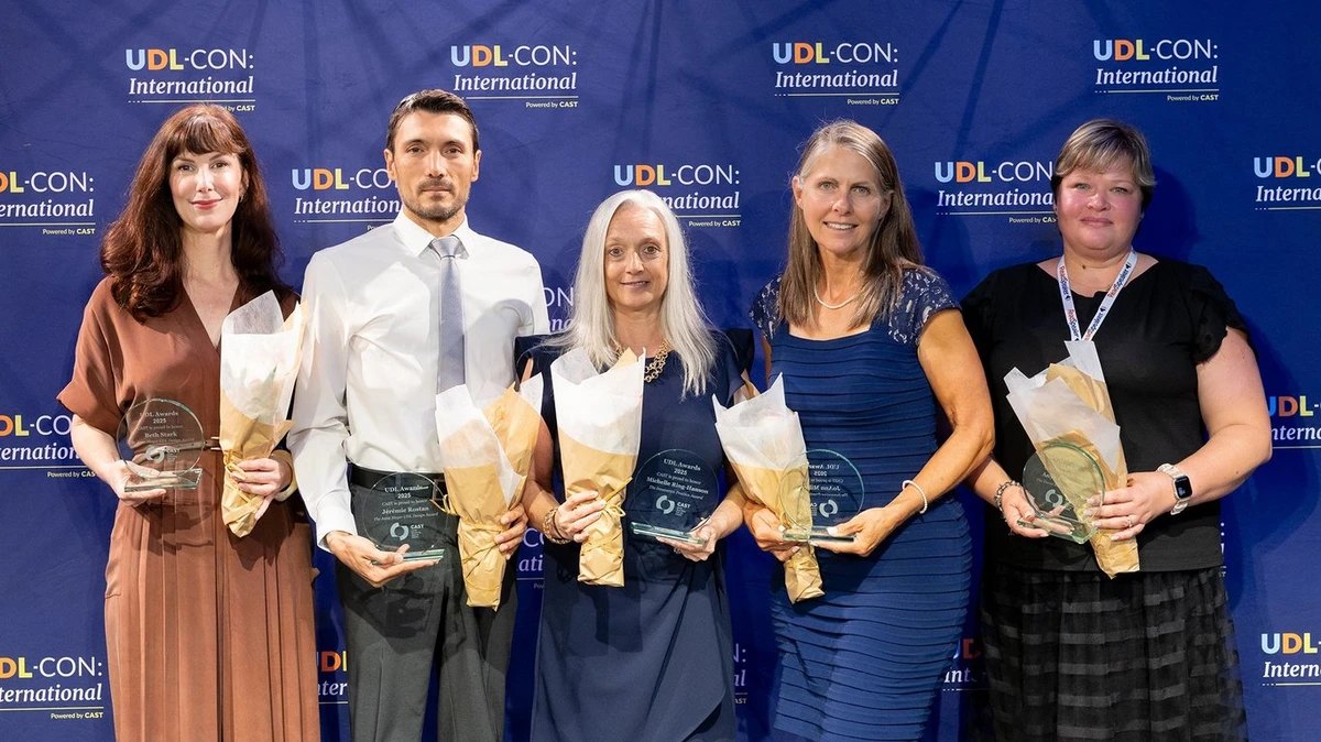 Five people standing together at UDL-CON: International.